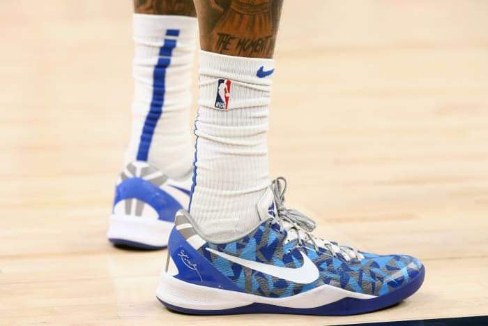 View of white and blue Nike Kobe shoes.